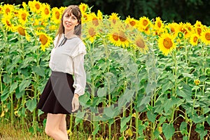 Young woman in a field of sunflowers.