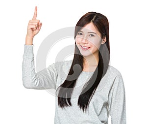 Young woman with finger pointing upwards