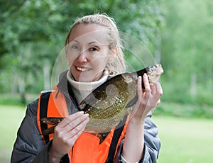 The young woman the fisherman with caught the bream