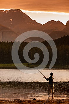 Young Woman fishing at Margaret Lake in the Waiparous area Alberta Canada