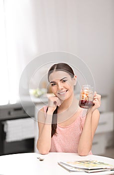 Young woman in fitness clothes having breakfast at home