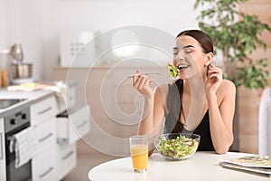 Young woman in fitness clothes having healthy breakfast at home