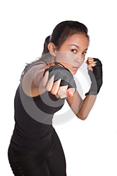 Young woman fitness trainer in combat pose photo