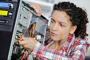 Young woman fix pc component in service center
