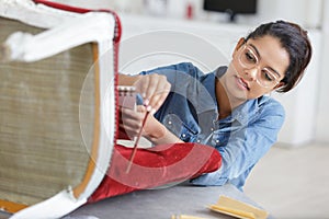Young woman fixing chair photo