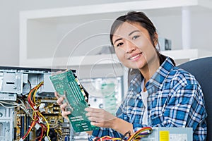 Young woman fixing computer