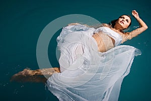 Young woman floating on swimming pool