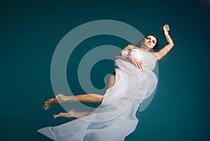 Young woman floating on swimming pool