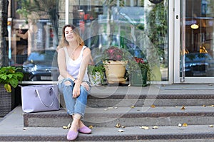 Young woman on the floor on the street looking in camera using p