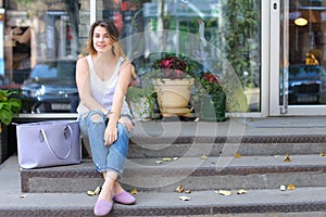 Young woman on the floor on the street looking in camera using p