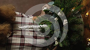 Young woman florist making Christmas flower arrangement. Vertical video.