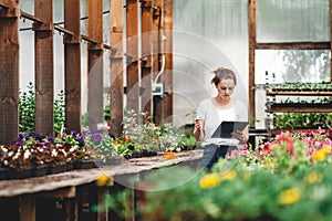 Young woman florist work in garden