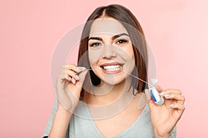 Young woman flossing teeth photo