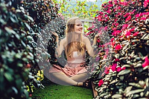 Young woman in a flower greenhouse. Bright tropical flowers.