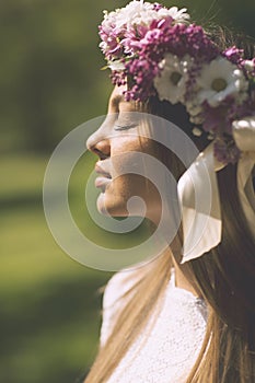 Young woman with flowers in a hair