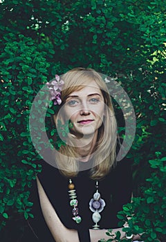 Young woman with flowers in her hair looking at camera