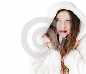 Young woman in fluffy fur coat with hood wrap, warm winter clothing for fashion and Christmas holidays