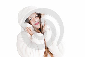 Young woman in fluffy fur coat with hood wrap, warm winter clothing for fashion and Christmas holidays