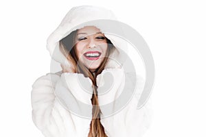 Young woman in fluffy fur coat with hood wrap, warm winter clothing for fashion and Christmas holidays