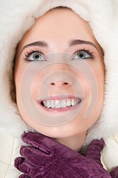 Young woman with fluffy hood, winter gloves