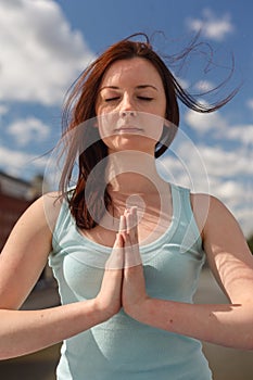 Young woman with flying hair in meditation