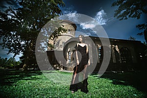 Young woman in formal dress on a castle background