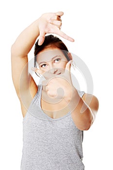 Young woman frame her face