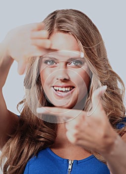 Young woman frame her face with hands.