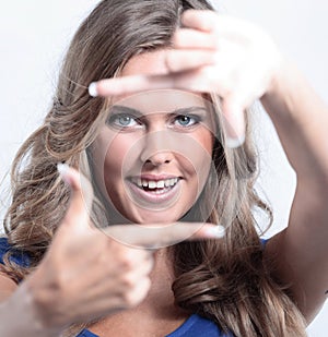 Young woman frame her face with hands