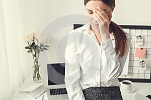 Young woman freelancer indoors home office concept formal style tired