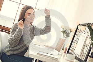 Young woman freelancer indoors home office concept winter atmosphere sitting listening music