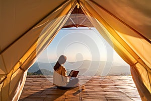 Young woman freelancer traveler working online using laptop and enjoying the beautiful nature landscape