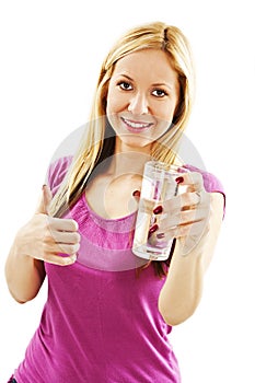 Young woman with fresh cold water in glass. Showing thumbs up