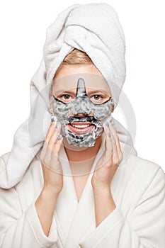 Young woman with fresh healthy skin and hairs aplying alginate mask and smiling. Cosmetology, beauty and spa. White