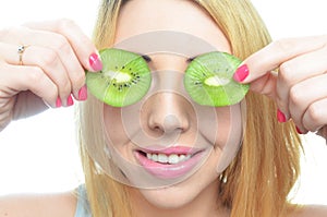 Young woman with fresh kiwi fruit