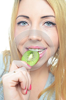 Young woman with fresh kiwi fruit