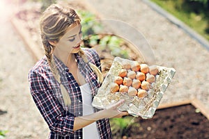 Young woman with fresh organic eggs