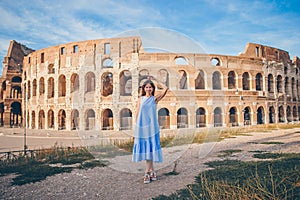 Young woman in front of colosseum in rome, italy