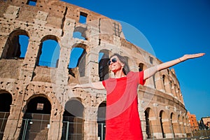 Young woman in front of colosseum in rome, italy