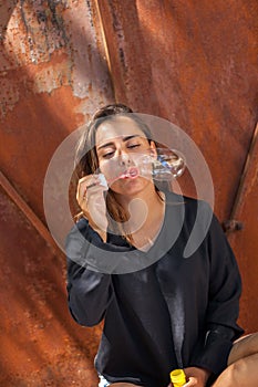 YOUNG WOMAN IN FRONT OF A RUSTY PORTAL