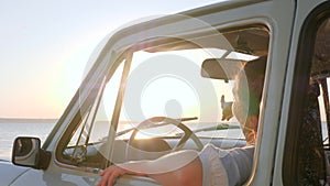 Young woman at front seat on car to coast sea