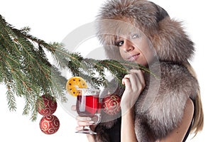 Young woman in fur with glass of mulled wine.