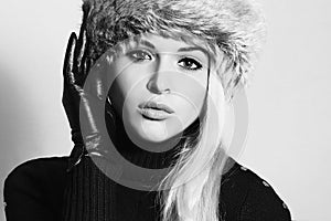 Young Woman in Fur Hat. Beautiful Blond Girl in Black Leather Gloves. Winter Fashion