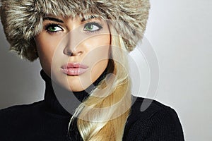 Young Woman in Fur Hat. Beautiful Blond Girl. Winter Fashion Beauty.Autumn.Healt hy hair