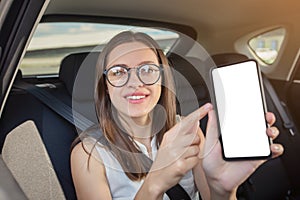 Young woman  with  gadget smartphone sitting in modern car