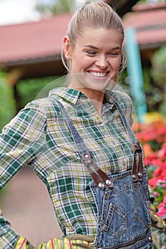 Young woman gardening in greenhouse.She selecting flowers