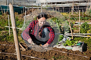 Young woman gardening in urban garden