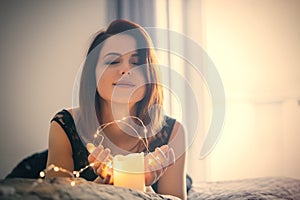 Young woman with garland and candle