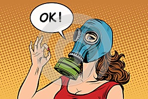 Young woman in gas mask okay gesture