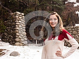 Young woman by a gate in winter